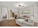 Bright living room features a large sectional sofa, entertainment center, and wood-look flooring at 951 Cutke Rd, St Cloud, FL 34771