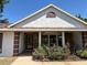Close-up view of the home's entrance with stone accents and established landscaping at 9538 Lavill Ct, Windermere, FL 34786