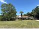 Spacious front yard with mature trees, offering shade and privacy to this single-story home at 9538 Lavill Ct, Windermere, FL 34786