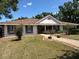 Charming single-story home featuring a well-manicured lawn, brick-lined driveway, and attractive shutters at 9538 Lavill Ct, Windermere, FL 34786