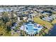 Stunning aerial view of community amenities with pool, tennis courts, and lake access at 1210 Pallister Ln, Lake Mary, FL 32746