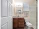 This bathroom offers a cherry wood vanity and a stylish framed mirror with complementary granite countertops at 1210 Pallister Ln, Lake Mary, FL 32746