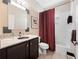 Bathroom featuring granite countertop, stylish mirror, and shower/tub combo with elegant curtain at 1210 Pallister Ln, Lake Mary, FL 32746