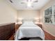 Comfortable bedroom featuring wood floors, ceiling fan, a window overlooking the backyard and neutral color scheme at 1210 Pallister Ln, Lake Mary, FL 32746