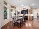 Bright dining room with hardwood floors, modern lighting, and stylish decor perfect for entertaining at 1210 Pallister Ln, Lake Mary, FL 32746