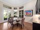 Elegant dining room featuring hardwood floors, modern lighting, and stylish decor, perfect for entertaining guests at 1210 Pallister Ln, Lake Mary, FL 32746