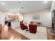 Open-concept living room and kitchen, with hardwood floors, comfortable seating, and modern appliances for easy living at 1210 Pallister Ln, Lake Mary, FL 32746