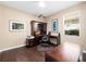 Home office boasts built-in wooden desk, matching shelving, and a comfortable leather chair at 1210 Pallister Ln, Lake Mary, FL 32746