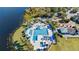Aerial view of a community pool, with cabanas, a slide, and inviting lounge areas by the lakeside at 1210 Pallister Ln, Lake Mary, FL 32746