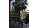 Balcony showcasing sitting area with table and chairs, overlooking a green space and parking lot at 12539 Floridays Resort Dr 411 # 411D, Orlando, FL 32821