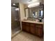 Bathroom features a glass shower, single vanity, and pass through to bedroom at 12539 Floridays Resort Dr 411 # 411D, Orlando, FL 32821