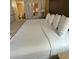 Bedroom features a soft bed with white linens, neutral walls, and soft carpet at 12539 Floridays Resort Dr 411 # 411D, Orlando, FL 32821