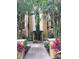 Beautiful building entrance with manicured landscaping and inviting architecture in a resort setting at 12539 Floridays Resort Dr 411 # 411D, Orlando, FL 32821