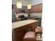Bright kitchen featuring stainless steel appliances, granite countertops and wooden cabinetry at 12539 Floridays Resort Dr 411 # 411D, Orlando, FL 32821