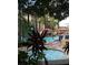Relaxing community pool and jacuzzi area with palm trees and comfortable lounge chairs for residents at 12539 Floridays Resort Dr 411 # 411D, Orlando, FL 32821