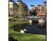 Exterior view of community pool and grounds featuring gazebo, lounge chairs and condo buildings at 12539 Floridays Resort Dr 411 # 411D, Orlando, FL 32821