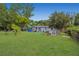 Expansive backyard featuring lush green grass and mature trees, perfect for outdoor activities and relaxation at 1604 Constantine St, Orlando, FL 32825