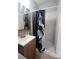 Bathroom featuring a shower with an artistic curtain and a decorative mirror above the sink at 1604 Constantine St, Orlando, FL 32825