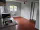 A cozy kitchen features wood-look flooring, natural light from the window, and essential appliances at 1604 Constantine St, Orlando, FL 32825