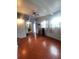 Cozy living room features hardwood floors, natural light, and mini kitchen with mini fridge and sink at 1604 Constantine St, Orlando, FL 32825