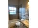 Tiled bathroom with a shower-tub combination and sleek vanity at 2600 Cedar Bluff Ln, Ocoee, FL 34761