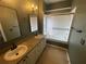 Bathroom featuring double sinks, vanity, and a bathtub with shower and sliding glass door at 2600 Cedar Bluff Ln, Ocoee, FL 34761