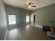 Spacious bedroom with modern flooring, a ceiling fan, and two windows offering abundant natural light at 2600 Cedar Bluff Ln, Ocoee, FL 34761