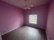 Bedroom featuring modern flooring, a ceiling fan, and a window offering ample natural light at 2600 Cedar Bluff Ln, Ocoee, FL 34761