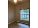 This bedroom features hardwood floors, a large window, and a ceiling fan at 2600 Cedar Bluff Ln, Ocoee, FL 34761