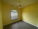 Bedroom featuring modern flooring, a ceiling fan, and a window offering ample natural light at 2600 Cedar Bluff Ln, Ocoee, FL 34761