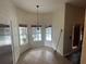 Bright breakfast nook with a chandelier and large windows overlooking the pool area at 2600 Cedar Bluff Ln, Ocoee, FL 34761