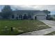 Charming single-story home featuring a well-maintained lawn and attached two-car garage at 2600 Cedar Bluff Ln, Ocoee, FL 34761