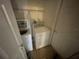 Interior laundry room featuring a washing machine, dryer, and overhead lighting at 2600 Cedar Bluff Ln, Ocoee, FL 34761