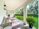 Relaxing back porch with brick flooring, offering a tranquil view of the well-manicured backyard and lush greenery at 3631 Arbordale Loop, Sanford, FL 32771