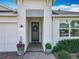 Close up on the front door of this home with decorative wreath and tasteful landscaping at 3631 Arbordale Loop, Sanford, FL 32771
