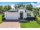 Charming single-story home featuring a well-manicured lawn, brick driveway, and a 2-car garage at 3631 Arbordale Loop, Sanford, FL 32771