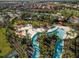 Aerial view of community with resort-style pool, lazy river, cabanas, and lush landscaping at 4582 Terrasonesta Dr, Davenport, FL 33837