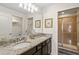 Bathroom with dual sinks, granite counters, framed art, and a glass enclosed shower at 4582 Terrasonesta Dr, Davenport, FL 33837