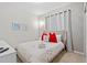 Bedroom with a neutral color scheme, floral accents, and cozy furnishings at 4582 Terrasonesta Dr, Davenport, FL 33837