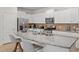 Kitchen featuring granite countertops, a large island, stainless steel appliances, and white cabinetry at 4582 Terrasonesta Dr, Davenport, FL 33837