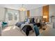 Bedroom with a chandelier and accent wall, mirrored bedside tables and large windows at 4582 Terrasonesta Dr, Davenport, FL 33837