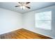 Bright bedroom featuring hardwood floors, a ceiling fan, and a window providing natural light at 8812 Kensington Ct, Kissimmee, FL 34747
