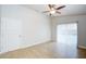 Bright bedroom with a ceiling fan and tile floors. Sliding glass doors offer a view of the pool at 8812 Kensington Ct, Kissimmee, FL 34747