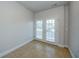 Cozy entryway with tiled floor and French doors with window slats at 8812 Kensington Ct, Kissimmee, FL 34747