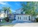 Charming two-story home with a combination of brick and stucco, complemented by lush trees at 8812 Kensington Ct, Kissimmee, FL 34747
