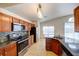 Kitchen featuring granite counters, stainless appliances and a view of the pool through the window at 8812 Kensington Ct, Kissimmee, FL 34747