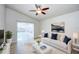 Comfortable living room featuring stylish furnishings, a ceiling fan, and sliding doors to the outdoor pool area at 8812 Kensington Ct, Kissimmee, FL 34747