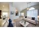 Bright open-concept space showcasing modern furniture, high ceilings, and seamless flow to the dining and kitchen areas at 8812 Kensington Ct, Kissimmee, FL 34747