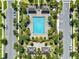 Aerial view of the community pool, parking and cabanas surrounded by lush landscaping at 10254 Beechwood Ln, Orlando, FL 32832