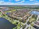 Expansive aerial view of a residential community featuring multiple lakes, lush landscaping, and tile roofs at 10254 Beechwood Ln, Orlando, FL 32832